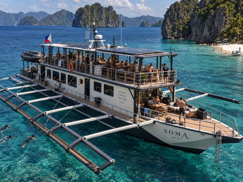 A SOMA double-deck expedition boat at anchor
