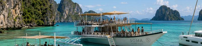 The flagship bangka and catamaran at anchor in Bacuit Bay