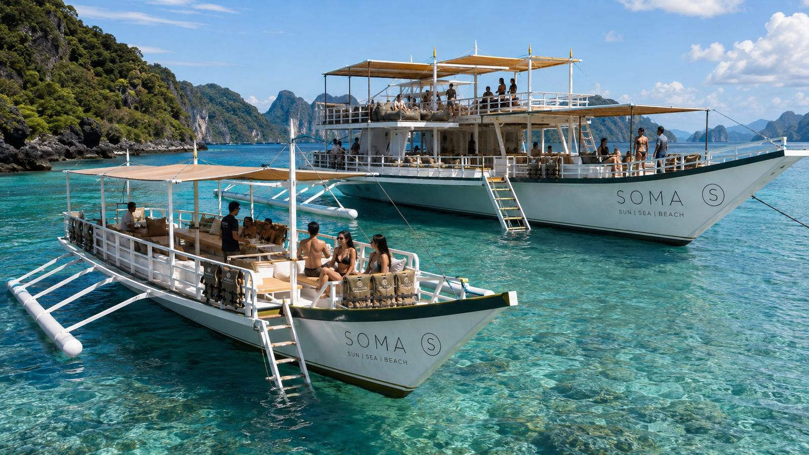 A SOMA boat at anchor in clear water below the limestone cliffs of Bacuit Bay