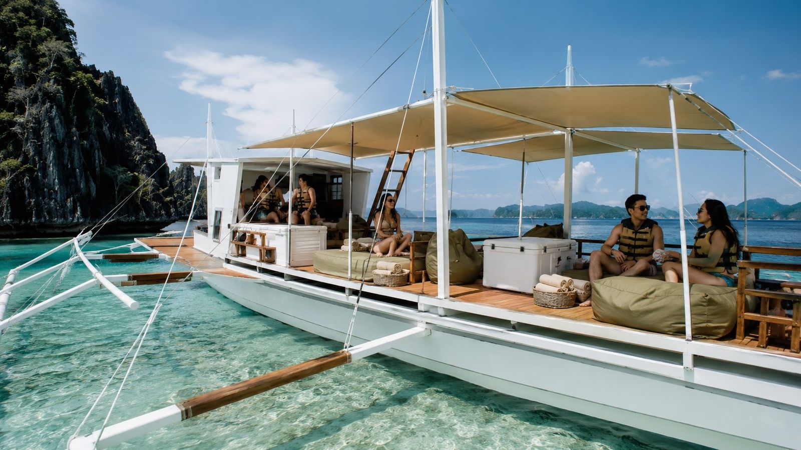Guests on the shaded deck of a SOMA outrigger between islands